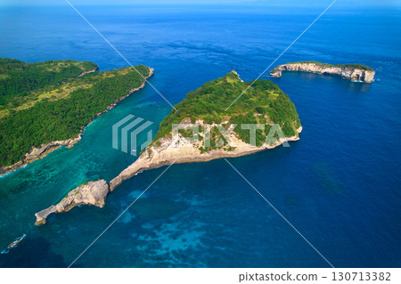 Cinematic aerial landscape shots of the beautiful island Diamond beach of Nusa Penida. Huge cliffs by the shoreline and hidden dream beaches with clear water. Cinematic aerial landscape shots of the beautiful island Diamond beach of Nusa Penida. Huge cliffs by the shoreline and hidden dream beaches with clear water. 130713382