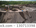 A stone quarry in Indonesia. Large equipment such as bulldozers and dump trucks are working on the site. 130713398