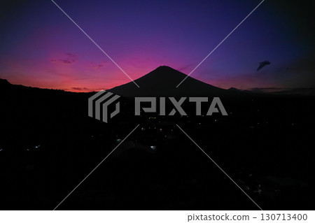 Silhouette of the Agung volcano at sunset. Panorama of the mountain on the island of Bali. Silhouette of the Agung volcano at sunset. Panorama of the mountain on the island of Bali. 130713400