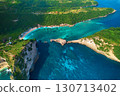 Cinematic aerial landscape shots of the beautiful island Diamond beach of Nusa Penida. Huge cliffs by the shoreline and hidden dream beaches with clear water. 130713402
