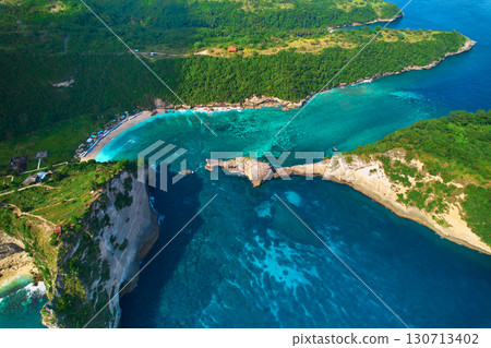 Cinematic aerial landscape shots of the beautiful island Diamond beach of Nusa Penida. Huge cliffs by the shoreline and hidden dream beaches with clear water. Cinematic aerial landscape shots of the beautiful island Diamond beach of Nusa Penida. Huge cliffs by the shoreline and hidden dream beaches with clear water. 130713402