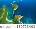 Cinematic aerial landscape shots of the beautiful island Diamond beach of Nusa Penida. Huge cliffs by the shoreline and hidden dream beaches with clear water. 130713403