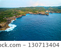 Cinematic aerial landscape shots of the beautiful island of Nusa Penida. Huge cliffs by the shoreline and hidden dream beaches with clear water. 130713404
