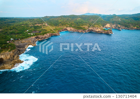 Cinematic aerial landscape shots of the beautiful island of Nusa Penida. Huge cliffs by the shoreline and hidden dream beaches with clear water. Cinematic aerial landscape shots of the beautiful island of Nusa Penida. Huge cliffs by the shoreline and hidden dream beaches with clear water. 130713404