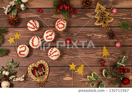 Winter background for greeting card. Curd muffins with pomegranates in glaze with numbers 2026 for festive table, idea for food decoration and New Year's dishes for children. Winter background for greeting card. Curd muffins with pomegranates in glaze with numbers 2026 for festive table, idea for food decoration and New Year's dishes for children. 130713567