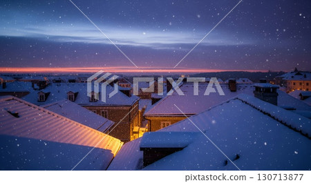 Snow Covered Rooftops at Dusk with Falling Snow in a Cityscape View 130713877