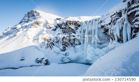 Scenic Waterfall Covered in Snow and Ice on Sunny Winter Day in Iceland 130714590