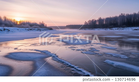 Frozen River At Sunset With Snow Covered Banks And Forest Background 130714696
