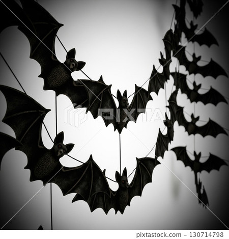 Creepy Halloween Decoration with Suspended Black Bats against a White Background 130714798