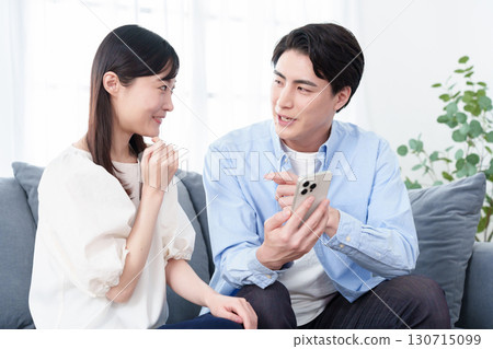 Young men and women using smartphones Young men and women using smartphones 130715099