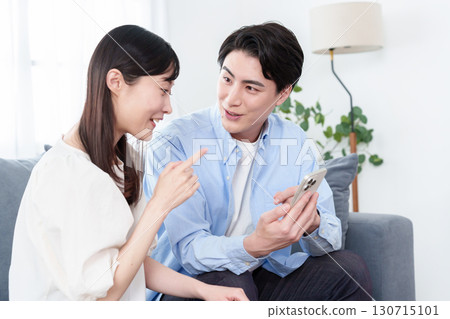 Young men and women using smartphones Young men and women using smartphones 130715101