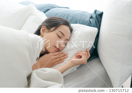 A young woman sleeping in bed A young woman sleeping in bed 130715712