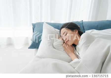 A young woman sleeping in bed A young woman sleeping in bed 130715715