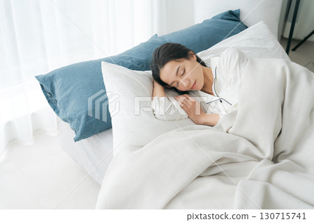 A young woman sleeping in bed A young woman sleeping in bed 130715741