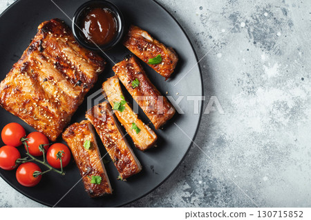 Closeup of pork ribs grilled with BBQ sauce and caramelized in honey. 130715852