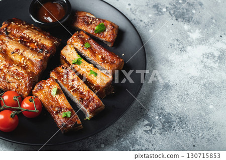 Closeup of pork ribs grilled with BBQ sauce and caramelized in honey. 130715853