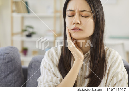 Upset Woman With Toothache At Home Upset Woman With Toothache At Home 130715917
