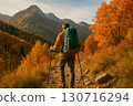 Hiker walking on autumn mountain trail 0034 130716294