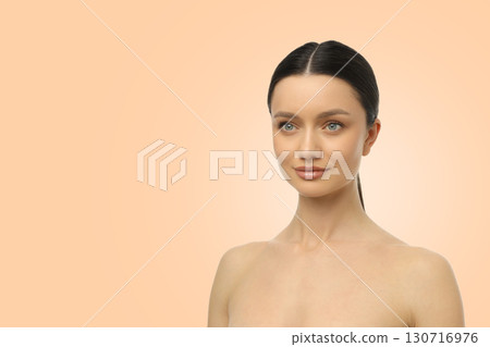 Model displaying flawless skin and subtle makeup in a studio 130716976