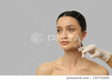 Cosmetic procedure being performed on a young woman's face Cosmetic procedure being performed on a young woman's face 130716980