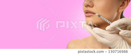 A pro applies lip filler for added fullness 130716986