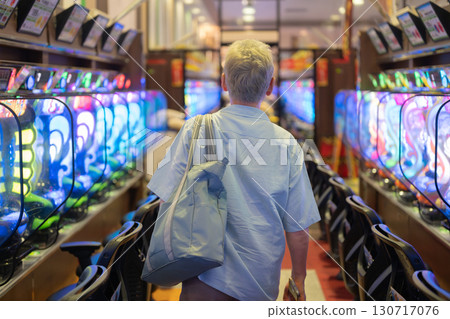 Men playing pachinko 130717076