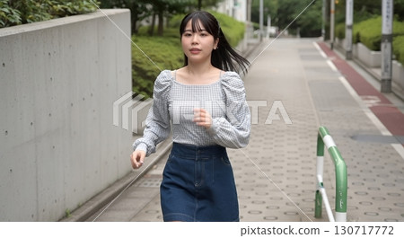 A woman running through a residential area A woman running through a residential area 130717772