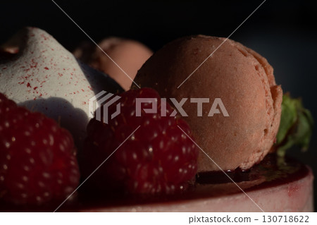 Close-Up of Raspberry and Macaron Dessert in Dramatic Lighting 130718622