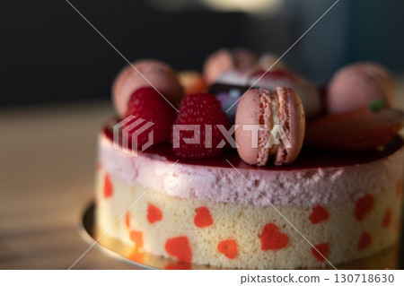 Elegant Raspberry Macaron Cake with Heart Patterns in Soft Sunlight 130718630