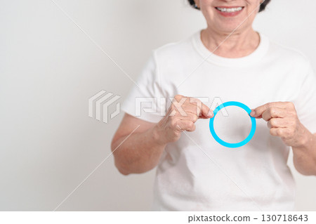 Elderly woman with Blue Circle for World Diabetes Day, Blue November Health month, Diabetes awareness, Blood sugar check, Insulin, Glucose screening, Healthy lifestyle, Chronic disease checkup 130718643