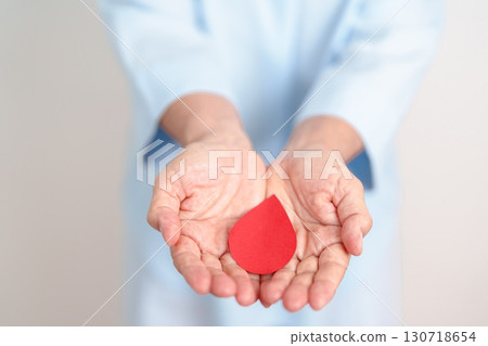 Elderly woman in blue shirt with red Blood drop for World Diabetes Day, Blue November Health month, Diabetes awareness, Blood sugar check, Insulin, Glucose screening, blood donoo and Health checkup 130718654