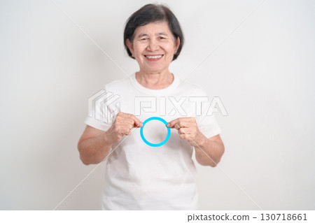 Elderly woman with Blue Circle for World Diabetes Day, Blue November Health month, Diabetes awareness, Blood sugar check, Insulin, Glucose screening, Healthy lifestyle, Chronic disease checkup Elderly woman with Blue Circle for World Diabetes Day, Blue November Health month, Diabetes awareness, Blood sugar check, Insulin, Glucose screening, Healthy lifestyle, Chronic disease checkup 130718661