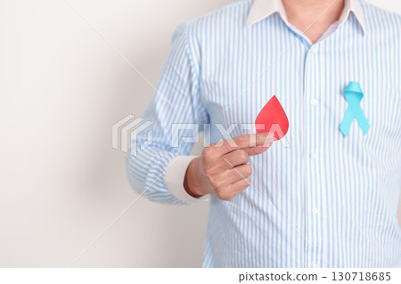 Man with Blue ribbon and red Blood drop for World Diabetes Day, Blue November Health month, Prostate Cancer awareness, Blood sugar check, Insulin, Glucose screening, donation and Health checkup Man with Blue ribbon and red Blood drop for World Diabetes Day, Blue November Health month, Prostate Cancer awareness, Blood sugar check, Insulin, Glucose screening, donation and Health checkup 130718685