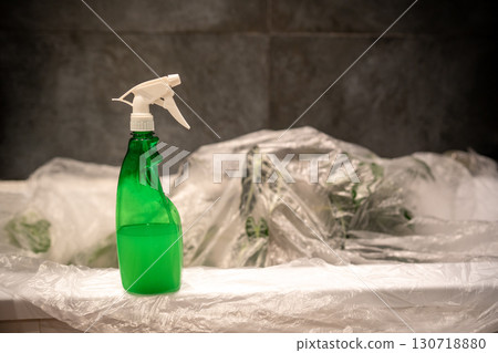 Treating houseplants with insecticide to kill spider mites. Spray bottle with acaricide closeup. Treating houseplants with insecticide to kill spider mites. Spray bottle with acaricide closeup. 130718880