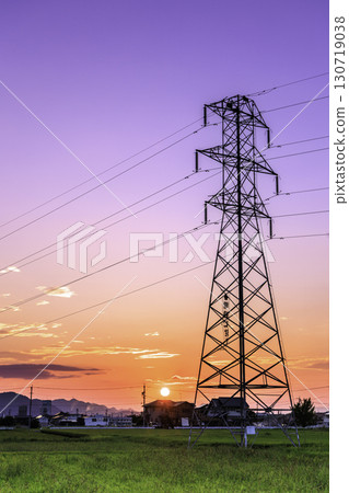 Power line tower standing at sunset in the countryside 130719038