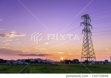 Power line tower standing at sunset in the countryside Power line tower standing at sunset in the countryside 130719040