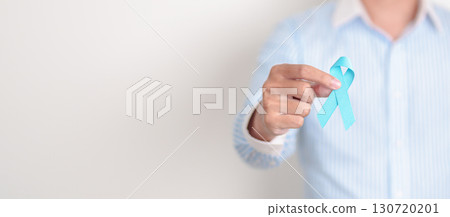 Man with blue Ribbon for concept of blue November, November Prostate Cancer Awareness month, World Diabetes day , Men Health month, International men, Father day. Healthcare and world cancer day Man with blue Ribbon for concept of blue November, November Prostate Cancer Awareness month, World Diabetes day , Men Health month, International men, Father day. Healthcare and world cancer day 130720201