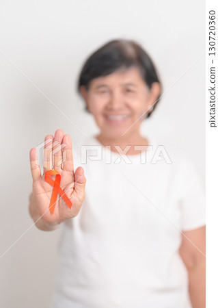 Elderly with Orange Ribbon for September Leukemia, March Kidney cancer day, Multiple Sclerosis, November Complex Regional Pain Syndrome, CRPS, COPD, Chronic Obstructive Pulmonary disease concepts 130720360