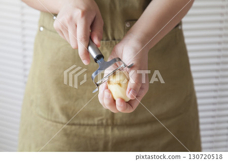 Woman peeling potatoes 130720518