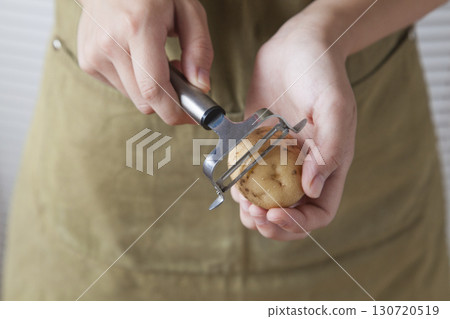 Woman peeling potatoes Woman peeling potatoes 130720519