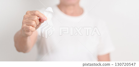 Elderly with White ribbon for concept November Lung Cancer Awareness month, Stop Violence Against Women, Adoption, May Retinoblastoma, Action for Women Health, March Remembrance, October Osteoporosis 130720547