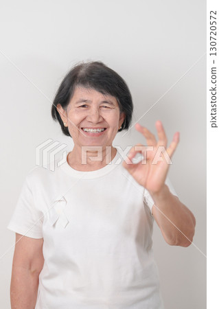 Elderly with White ribbon for concept November Lung Cancer Awareness month, Stop Violence Against Women, Adoption, May Retinoblastoma, Action for Women Health, March Remembrance, October Osteoporosis 130720572