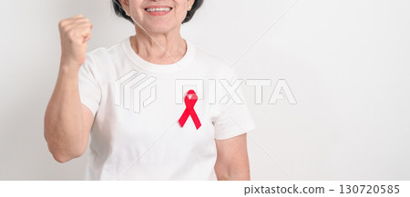 Elderly with Red Ribbon for December World Aids Day, MADD, October Red ribbon week, February Heart month, Marfan Syndrome, May Stroke awareness, March world TB Tuberculosis day and April Dare day 130720585