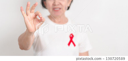 Elderly with Red Ribbon for December World Aids Day, MADD, October Red ribbon week, February Heart month, Marfan Syndrome, May Stroke awareness, March world TB Tuberculosis day and April Dare day 130720589