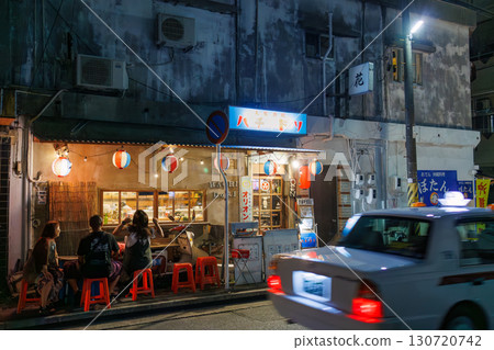 The quaint exterior features neon lights. An outdoor counter with old scooters and other items. Enjoy a late-night drink in Okinawa's largest entertainment district. The quaint exterior features neon lights. An outdoor counter with old scooters and other items. Enjoy a late-night drink in Okinawa's largest entertainment district. 130720742