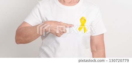 Elderly with Yellow Ribbon for concept of yellow September, Suicide prevention day, Childhood, July Sarcoma, support Our Troops and Military support. Healthcare and World Cancer day 130720779