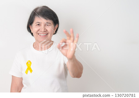 Elderly with Yellow Ribbon for concept of yellow September, Suicide prevention day, Childhood, July Sarcoma, support Our Troops and Military support. Healthcare and World Cancer day 130720781