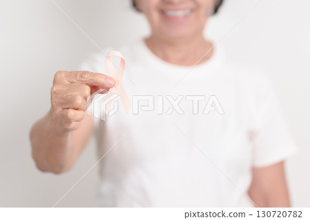 Elderly woman with Peach Ribbon for September Uterine Cancer Awareness month, Endometrial Cancer, Gynecologic, Uterus and Ovaries, Endometriosis, June Vaginal cancer and World cancer day concept Elderly woman with Peach Ribbon for September Uterine Cancer Awareness month, Endometrial Cancer, Gynecologic, Uterus and Ovaries, Endometriosis, June Vaginal cancer and World cancer day concept 130720782