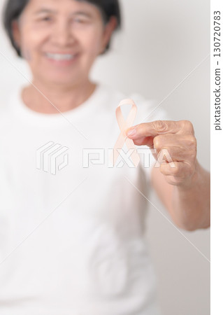 Elderly woman with Peach Ribbon for September Uterine Cancer Awareness month, Endometrial Cancer, Gynecologic, Uterus and Ovaries, Endometriosis, June Vaginal cancer and World cancer day concept 130720783
