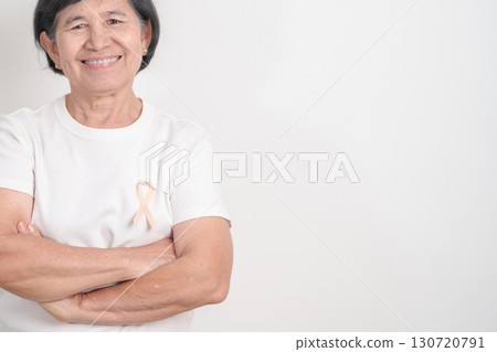 Elderly woman with Peach Ribbon for September Uterine Cancer Awareness month, Endometrial Cancer, Gynecologic, Uterus and Ovaries, Endometriosis, June Vaginal cancer and World cancer day concept 130720791
